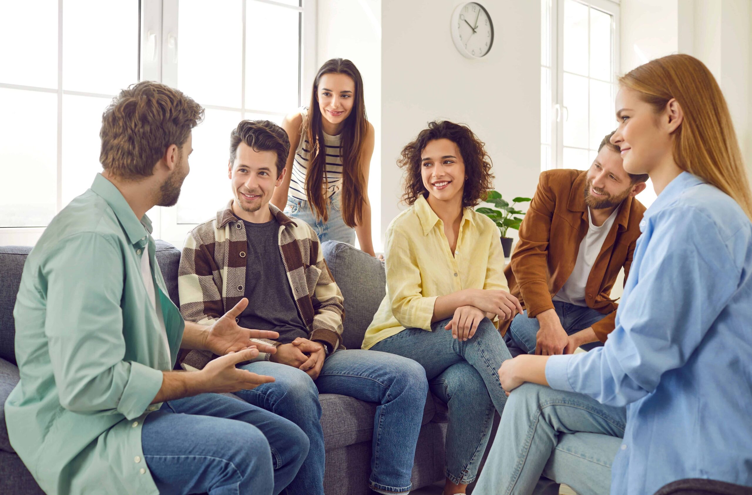 Group of men and women talking about How Does Sober Living Work?